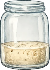 Small amount of sourdough starter in a jar